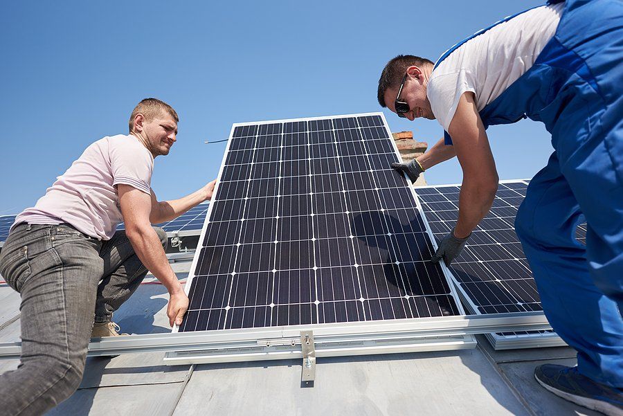 two man installing solar panel